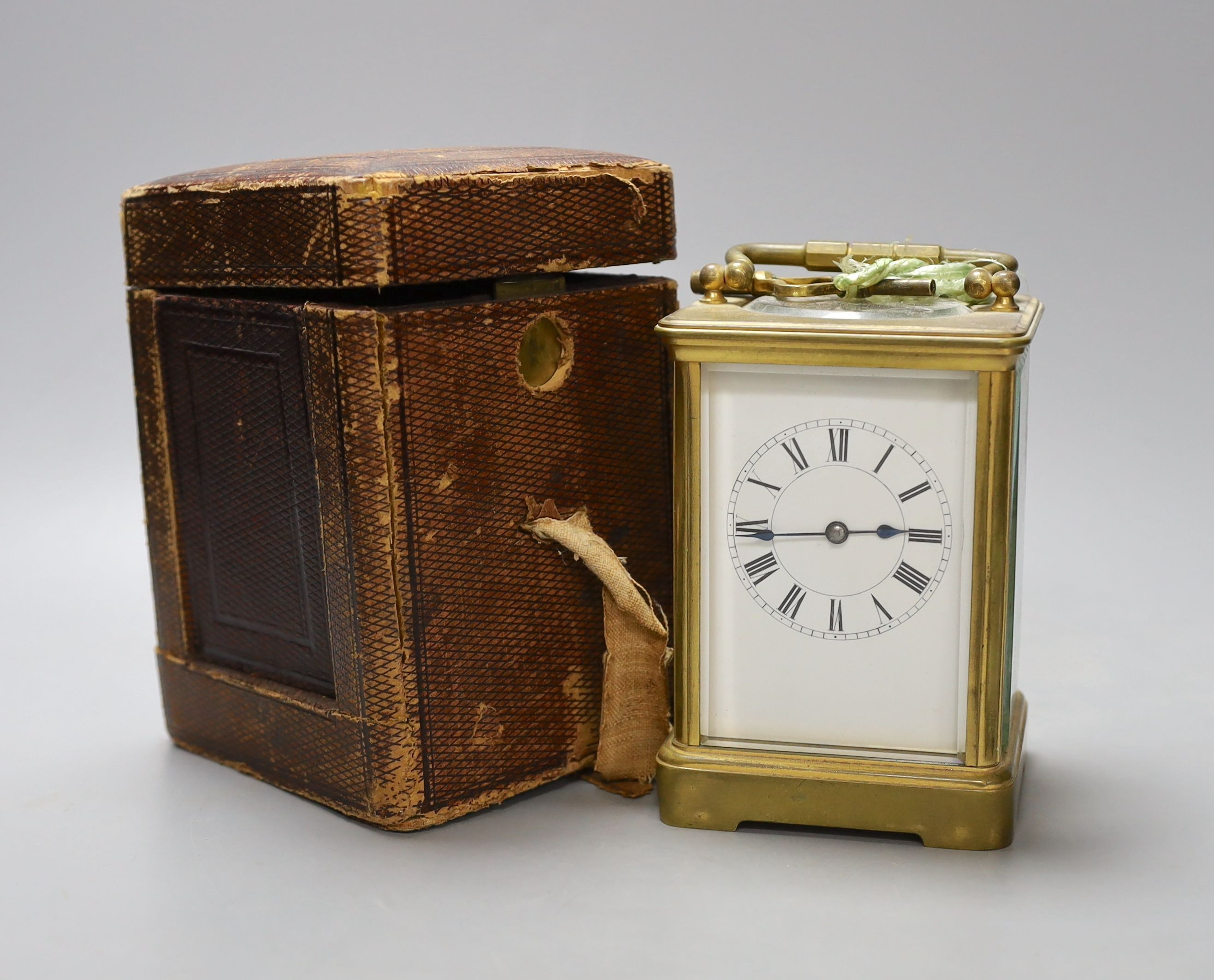 A leather cased brass carriage clock